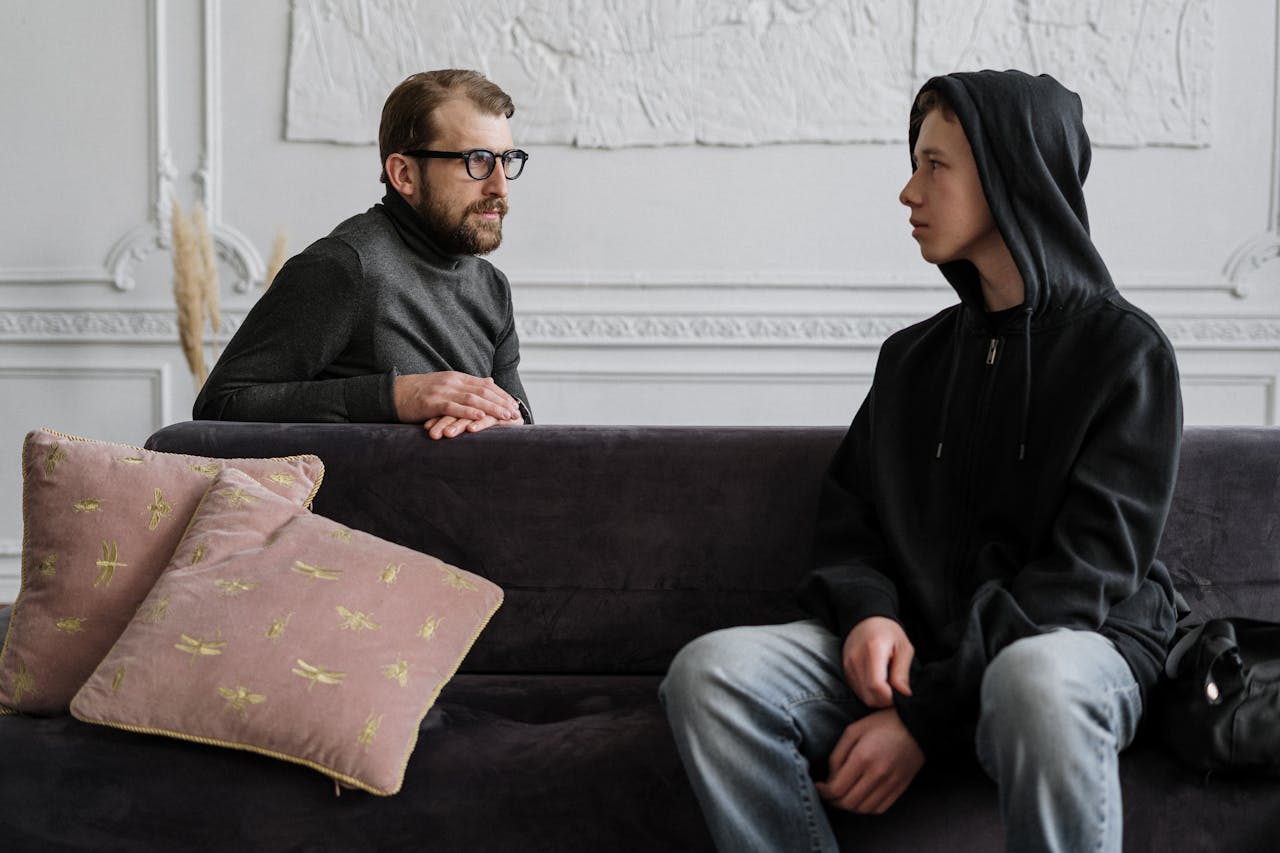 footer-cta A therapist and teenager in a counseling session, indoors with a warm setting.